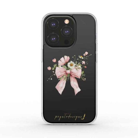 Clear phone case with centered pink floral bow and ribbon detail on dark backing